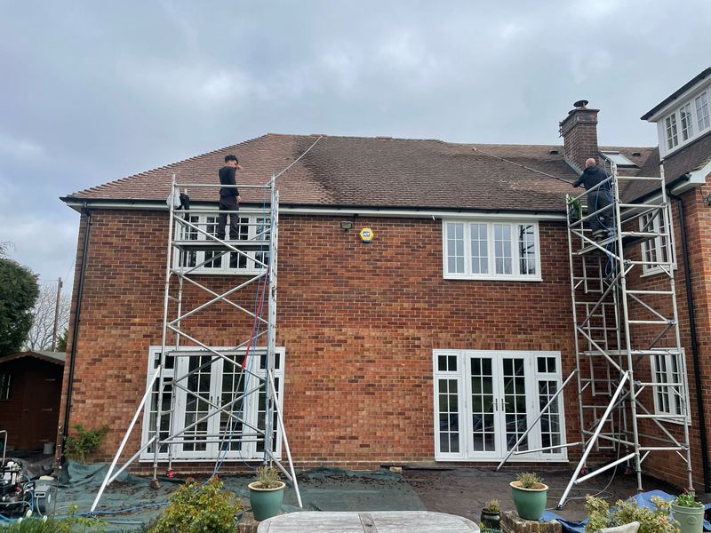 Roof cleaning carried out safely from scaffold towers by The Roof Moss Cleaners in Clapham